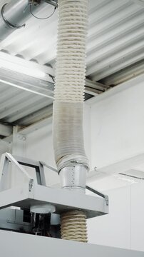 Industrial dust extraction and ventilation system connected to woodworking equipment for efficient dust collection and clean factory air.