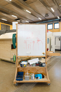 Framing diagrams hand drawn on whiteboard at wooden teaching station in vocational carpentry workshop
