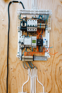 Complex training electrical panel containing circuit breakers and colored wiring arrays mounted onto wooden plywood