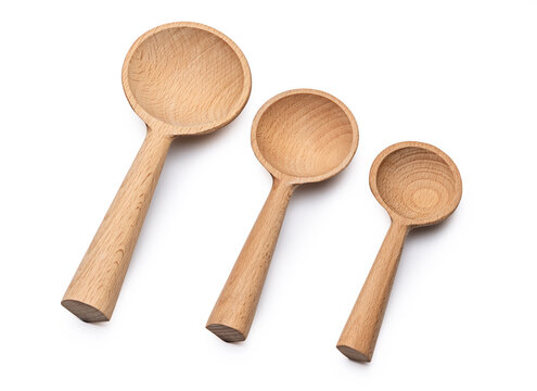Set of three wooden measuring spoons of different sizes isolated on white background
