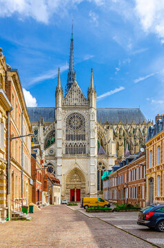 Amiens cityscape of old historical city centre with narrow pedestrian street, typical buildings and Amiens Cathedral Basilica of Our Lady Notre-Dame, vertical view, Hauts-de-France Region, France