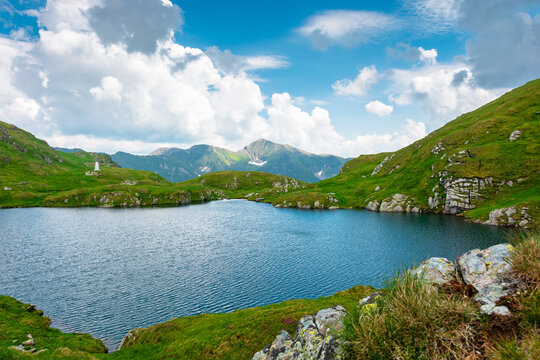lake in romania mountain landscape. clear source of water. outdoor adventures in summer. cloudy sky over the fagaras ridge