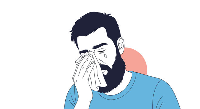 Sad bearded man in a blue t-shirt crying and wiping his eyes with a white tissue to express grief, sorrow, or emotional vulnerability.