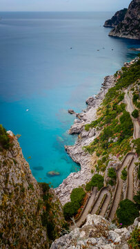 Aerial drone view of Via Krupp winding stairs with breathtaking landscape on Capri Island, Italy, dramatic cliffs, turquoise sea and iconic Mediterranean coastal scenery
