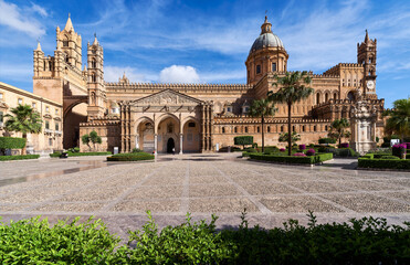 Fototapeta premium PALERMO, ITALY - JUNE, 2026: Exterior view of the historic Palermo Cathedral with its Arab-Norman architecture under a blue sky on a sunny day