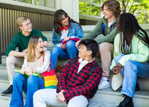 Happy Multiethnic Student Friends Relaxing Together on School Steps Outdoors
