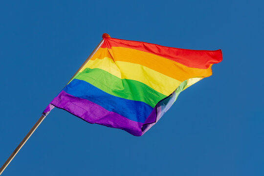 Celebration of pride month in Amsterdam, Colourful rainbow flag hanging on the window, The symbol of Gay, Lesbian, Bisexual and Transgender, LGBT community in Holland, Social movements, Netherlands.