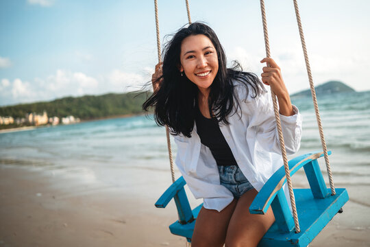 Trendy young traveler enjoying sunny weather and coastal breeze on a luxury tropical island resort