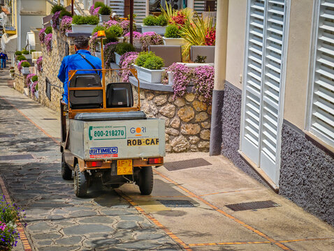 07 01 2026 - Capri, Italy. Special luggage transport vehicle on Capri Island carrying bags and suitcases through narrow mountain streets, scenic Italian island travel and Mediterranean landscape
