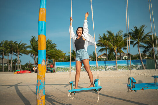 Mindful woman connecting with nature and feeling the breeze during a peaceful morning on the beach