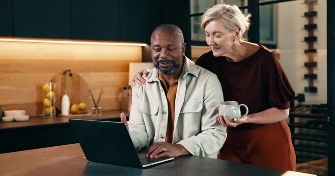 Coffee, laptop and couple in kitchen at house for reading online blog on finance tips or advice. Interracial people, computer and mature man hug woman for financial planning with bonding in home.