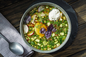Bowl of russian okroshka cold soup with vegetables and egg © Yingko