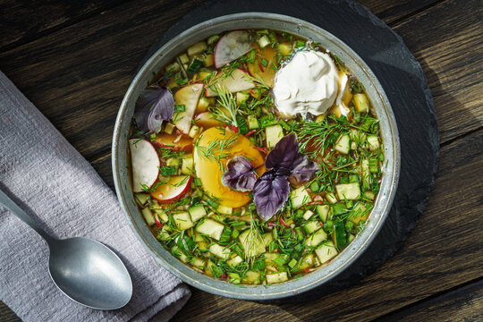 Bowl of russian okroshka cold soup with vegetables and egg