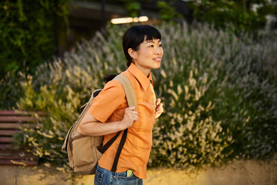 Young asian woman walking down the street or a tourist sightseeing