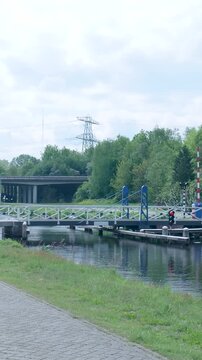 Dutch bascule bridge opening over a canal in the netherlands