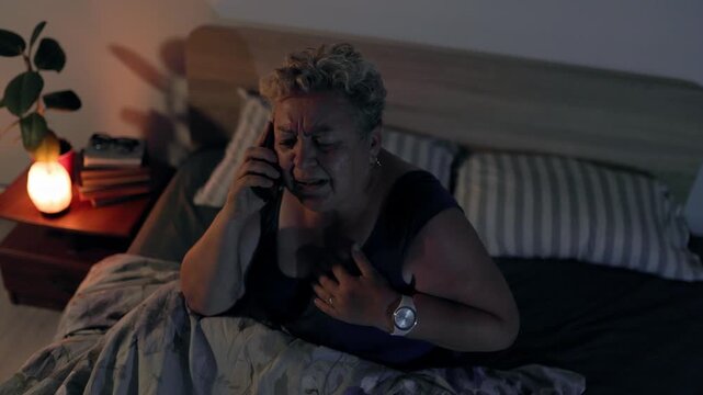 Overweight Distressed Senior Woman Calling Emergency For Chest Pain In Bed