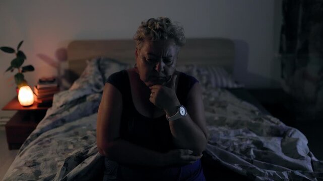 Overweight Sad Mature Woman Sitting In Bed At Night Being Deep In Thought
