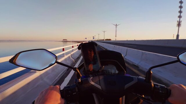 First Person Ride Across Benoa Toll Road Near Bandara Ngurah Rai With Scooter Handlebars And Coastal Highway At Sunrise