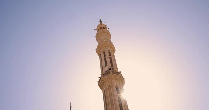 Ornate mosque with domes and a tall minaret in Sharm El Sheikh Egypt beneath a clear blue sky and generous copy space
