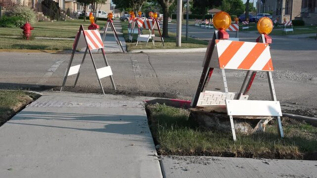 Construction barricades with warning lights on a suburban street. Suitable for roadwork, infrastructure maintenance, and public safety concepts. Urban infrastructure, public safety, and road work.