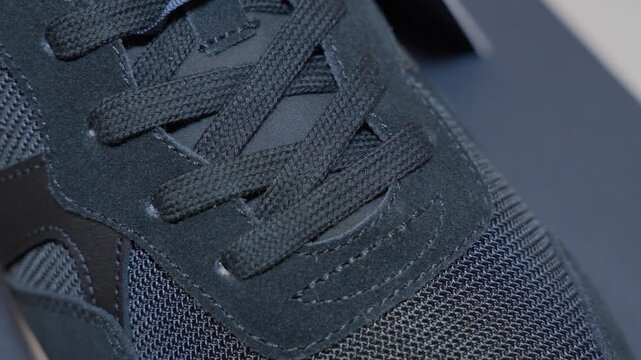 black running shoe close up for footwear product presentation with textured mesh and shoelace detail