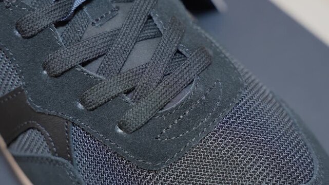 black sneaker detail close up for ecommerce product showcase with mesh fabric and lace texture