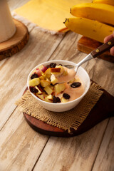 Fototapeta premium Yogurt with apple and dried cranberries, a light and healthy option to start breakfast.