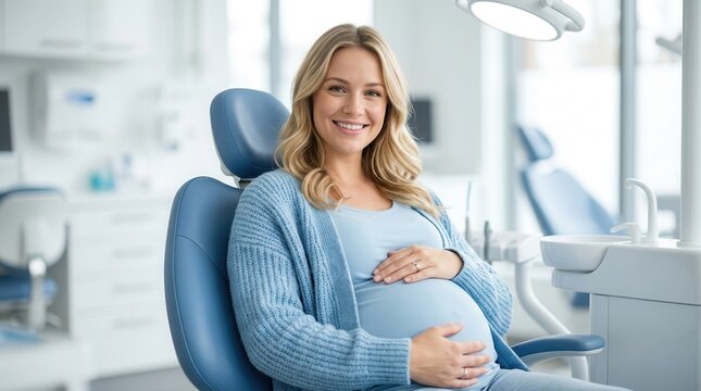 A smiling pregnant woman sitting on a dentist chair for maternal dental care.