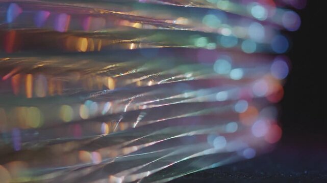 Abstract iridescent texture with shimmering colorful bokeh lights.