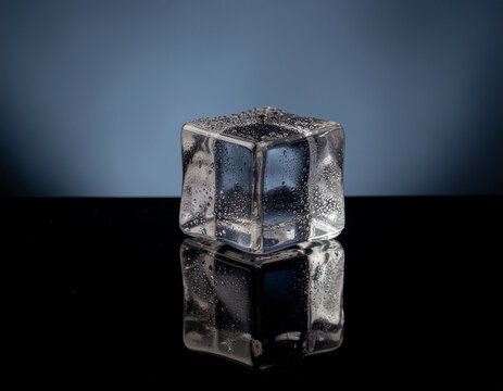 clear ice cube with realistic reflections and dramatic studio lighting