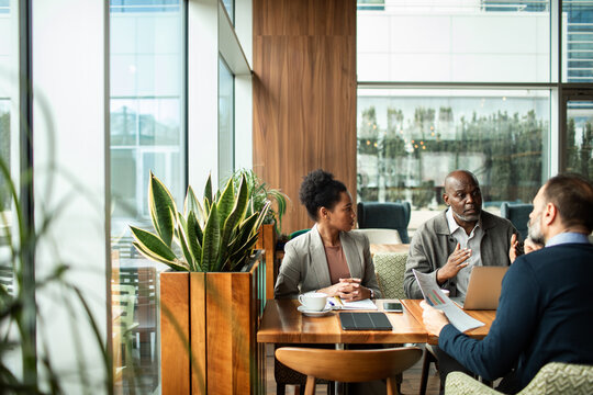 Business team discussing strategy in modern cafe