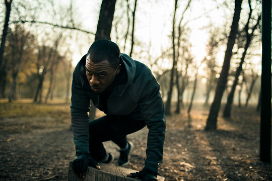 Determined athlete training outdoors in forest park