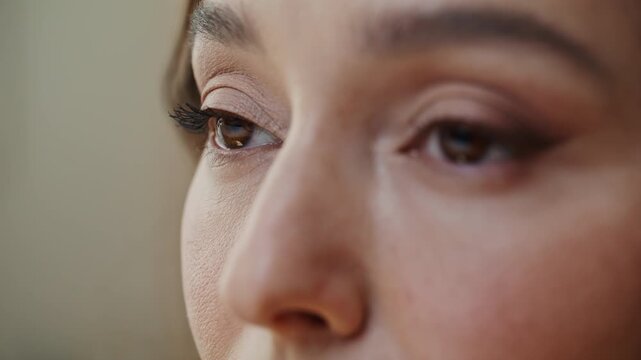 Closeup brown woman eyes with elegant bright makeup looking forward. Lady face