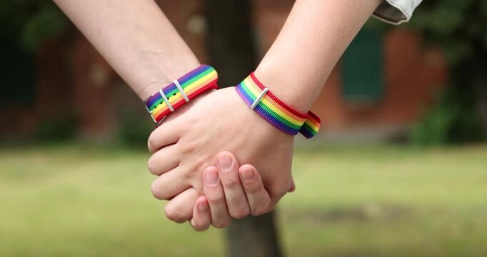 LGBT. People holding hands together outdoors, closeup