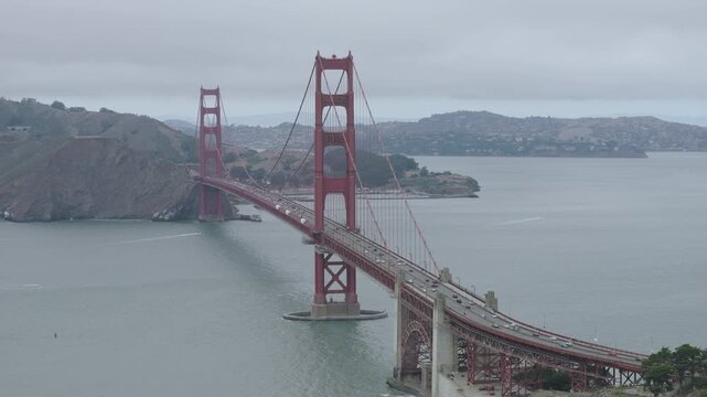 Golden Gate Bridge In San Francisco Bay With Overcast Sky - Cinematic Aerial Shot Above