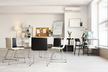 Fototapeta premium Empty modern support group meeting room with chairs in circle