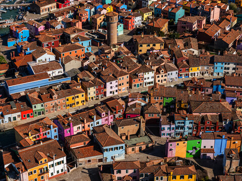 Aerial view of the colorful houses of Burano island with terracotta rooftops and narrow streets in Venice, Veneto, Italy.
