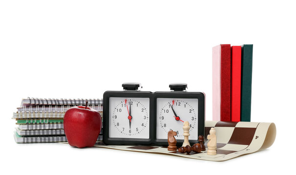 Composition with chess pieces, clock and notebooks on white background