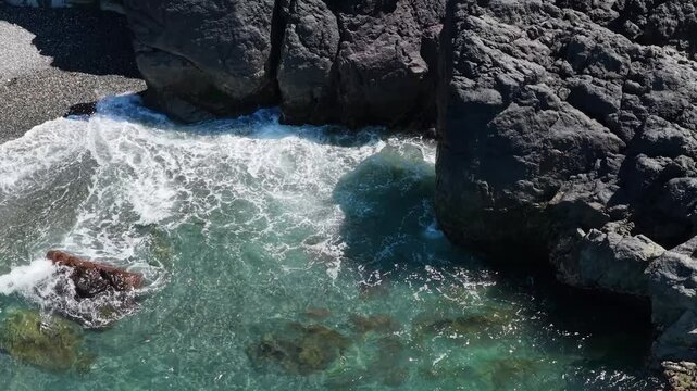 Powerful Waves Crashing Against Rugged Rocks and Pebble Shoreline at Otter Point, Vancouver Island