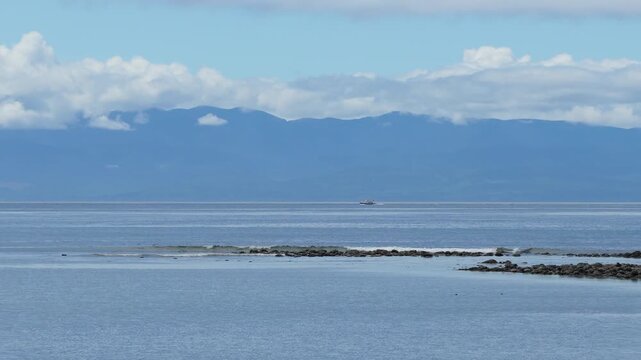 Serene Pacific Ocean View with Distant Boat and Majestic Mountains on Vancouver Island, British Columbia
