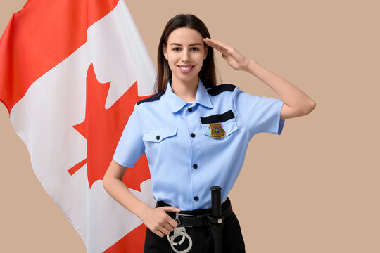 Saluting female police officer and flag of Canada on beige background