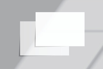 Fototapeta premium Blank white A4 paper sheets mockup on background with elegant organic shadow overlay. Perfect for displaying stationery designs, flyers, posters, branding, Ads and print design presentations