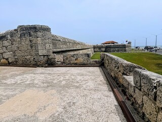 Fototapeta premium Cartagena Columbia 6-26-2026 Views of the massive 11-kilometer stone wall defenses enclose a maze of vibrant colonial buildings. It took over 200 years to fully complete the military structure.