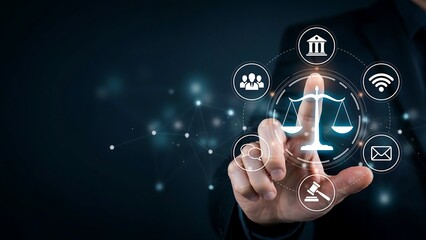 Fototapeta premium A person interacts with futuristic law and technology icons on a dark background with their index finger.