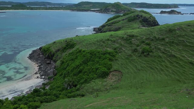 Woman Photographing Coastal Green Ridge with Mobile Phone, Wide Ocean Panorama, Dramatic Cloudy Sky, Island Silhouettes, Standing On Summit, Content Creator Pose, ,Bukit Merese, Lombok
