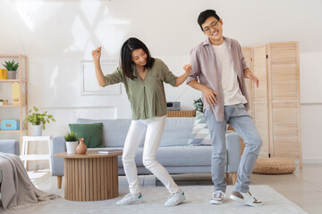 Fototapeta premium Young Asian friends dancing at home