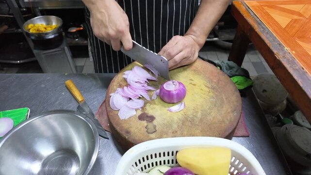 Professional Chef Slicing Red Onions with Cleaver in Commercial Kitchen