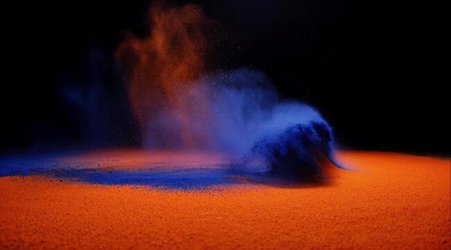 Colorful powder explosion background with abstract dust cloud splash over bright orange surface and deep blue cloud under dark studio light creating dramatic dynamic art scene