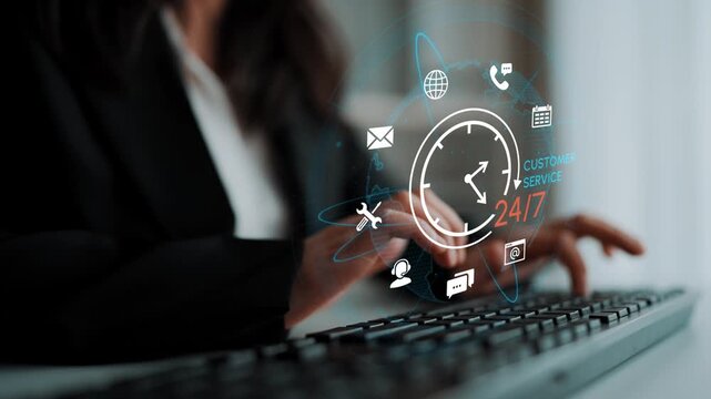 Business professional typing on keyboard with holographic customer service symbols and clock indicating 24-7 availability in a modern office environment. Entropy.
