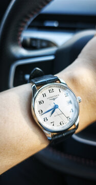 BANGKOK, THAILAND - JUNE 27 : Longines Master Collection, numeric marker, white dial in stainless steel case with alligator strap wear on wrist in Bangkok, Thailand, on June 27, 2026.